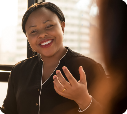 A lady smiling while talking.