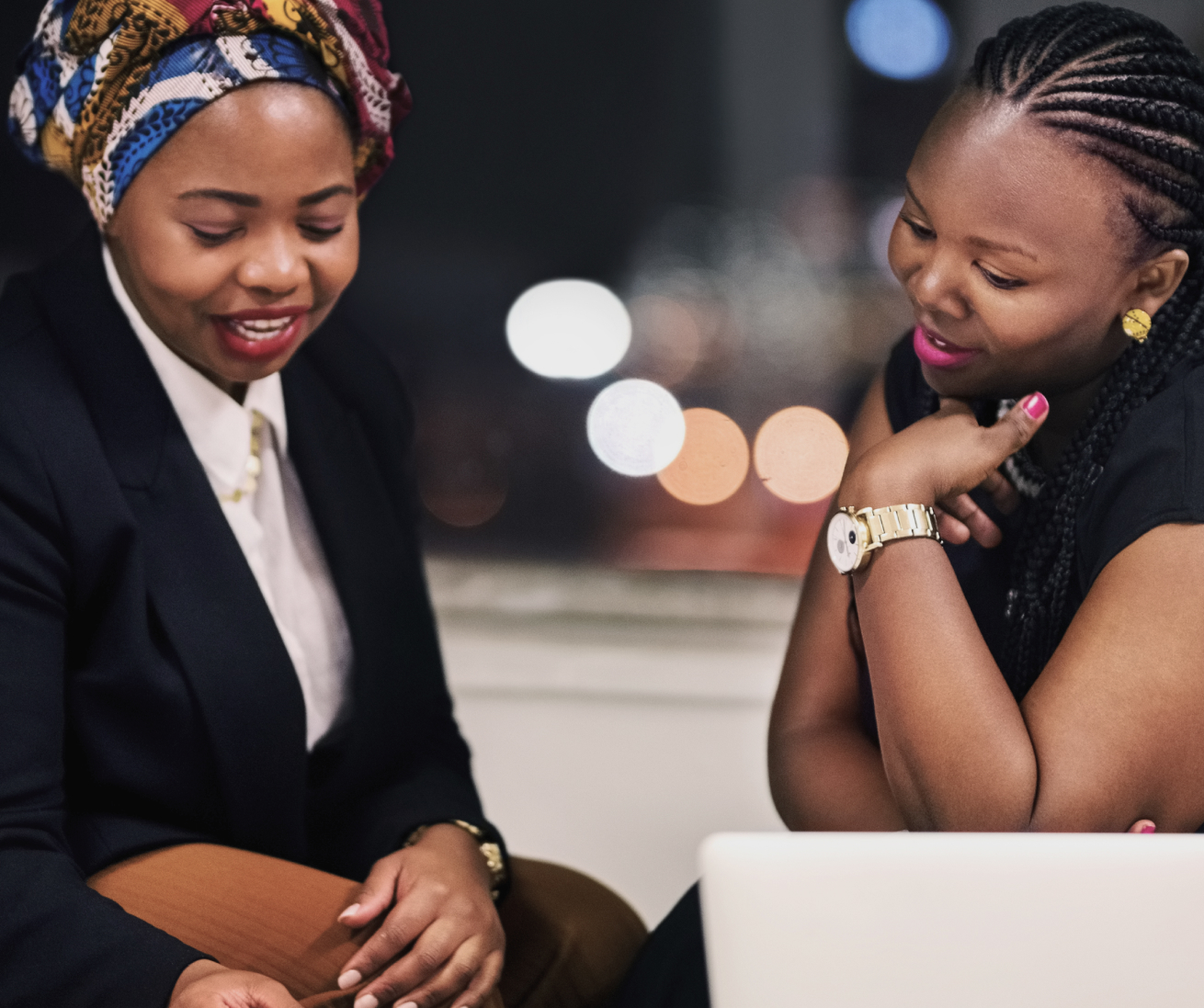 Two businesswomen going through legal documents.