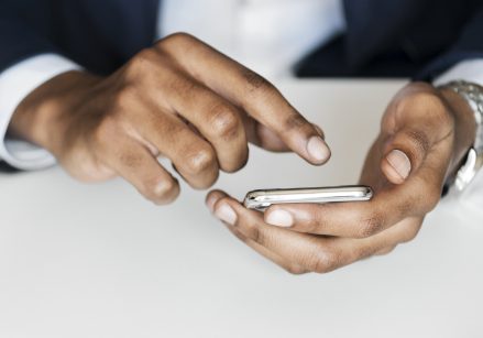 A man using his iPhone.